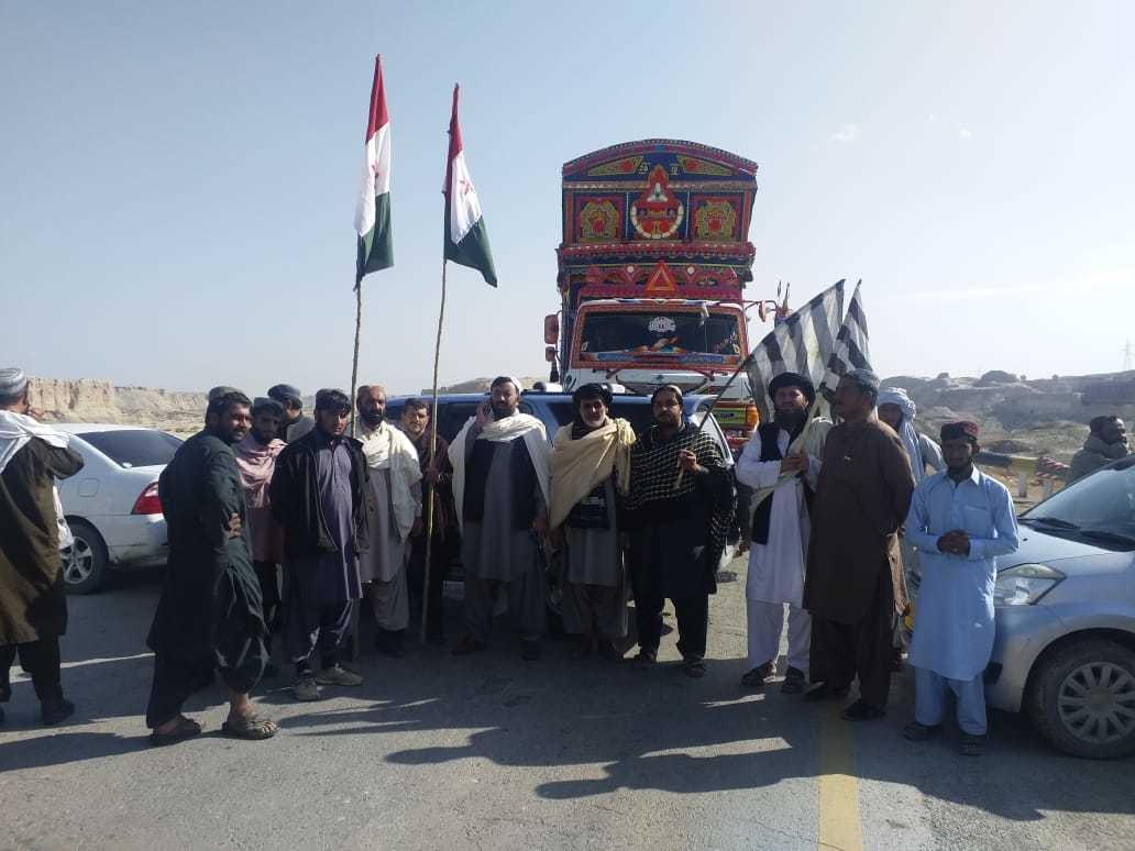 JUI-F and PkMAP workers block a road at the Syed Hameed Cross area. — Photo provided by Syed Ali Shah
