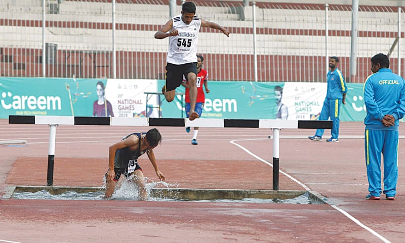 AN athlete jumps over an obstacle during the men&rsquo;s steeplechase event at the Qayyum Stadium on Thursday.&mdash;PPI