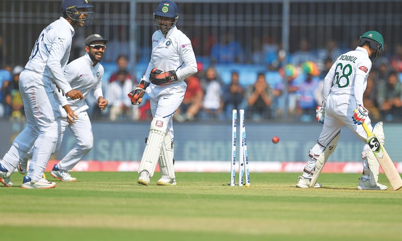 (L-R) India&rsquo;s Mayank Agarwal, Ajinkya Rahane and Wriddhiman Saha celebrate as Bangladesh captain Mominul Haque is dismissed during the first Test at the Holkar Cricket Stadium on Thursday.&mdash;AFP