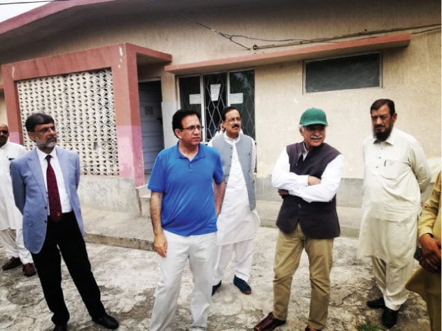 Special Assistant to the Prime Minister on Health Dr Zafar Mirza inspects an under-construction basic health unit in Kirpa. — Photo by the writer