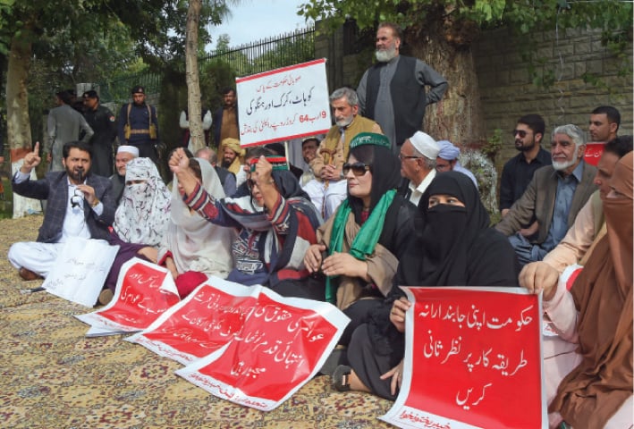 Opposition members stage a protest sit-in outside the CM secretariat, Peshawar, on Tuesday. — White Star