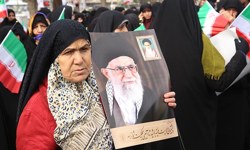 Iranian government supporters rally on November 20 in support of the Islamic republic's authorities and supreme leader, Ayatollah Ali Khamenei (portraits), in the cenral city of Arak, southwest of the capital Tehran, as President Hassan Rouhani said the country's people had defeated an "enemy conspiracy" behind a wave of violent street protests. — AFP