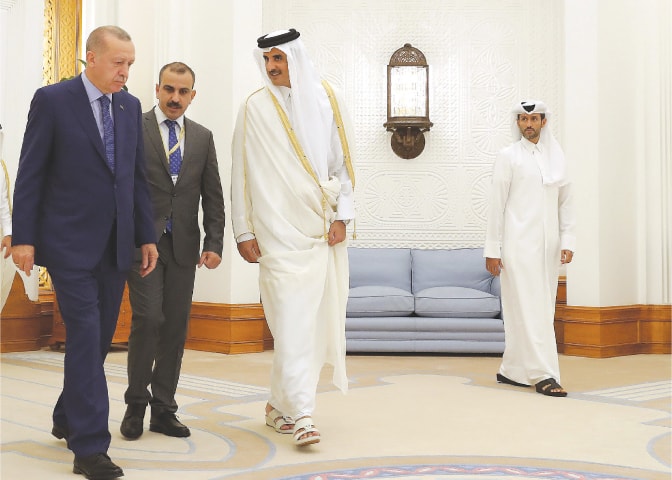 Doha: Qatar’s Emir Sheikh Tamim bin Hamad al-Thani welcoming Turkish President Recep Tayyip Erdogan on Monday.—AFP