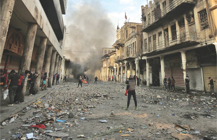 Baghdad: Iraqi demonstrators clash with security forces on Al Rashid street amid ongoing anti-government protests on Wednesday.—AFP