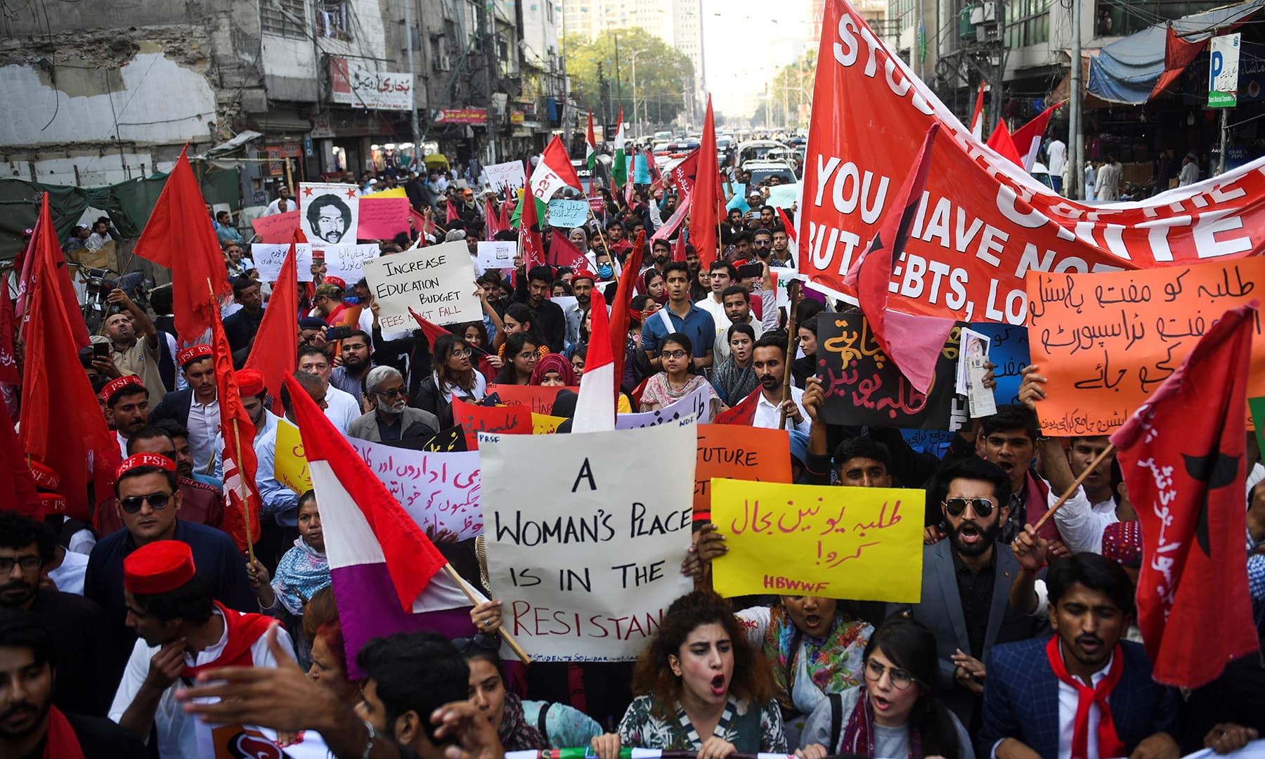 The streets of Karachi turned red with communist posters and flags in the protest march on Friday. — AFP