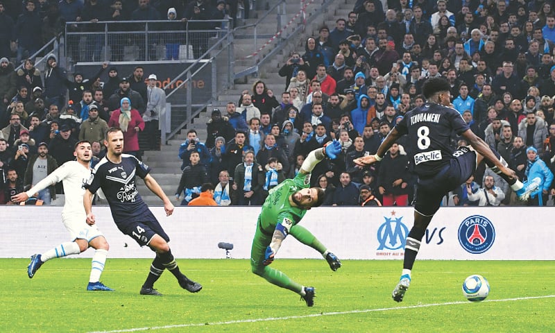 MARSEILLE: Olympique de Marseille’s Nemanja Radonjic (L) scores past Girondins de Bordeaux goalkeeper Benoit Costil during their Ligue 1 match at the Velodrome Stadium.—AFP