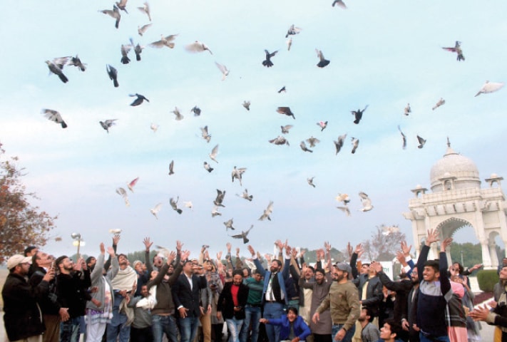 Civil society activists release pigeons in F-9 Park in Islamabad on Tuesday to mark the 71st anniversary of the UN Declaration of Human Rights and also inform the international community about the deplorable situation in India-held Kashmir. — Photo by Mohammad Asim