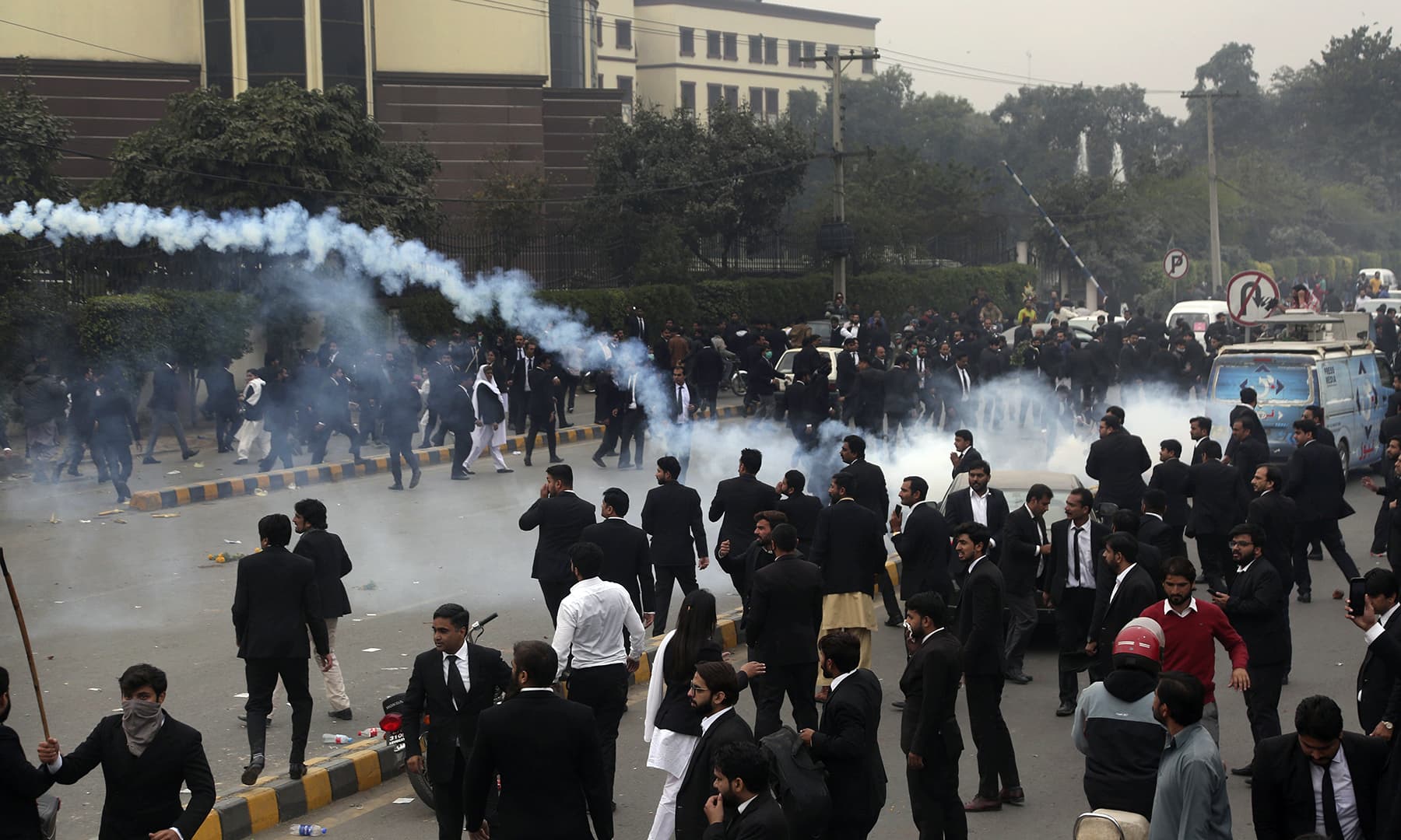 Police use tear gas shell to disperse angry lawyers during a clash in Lahore. — AP