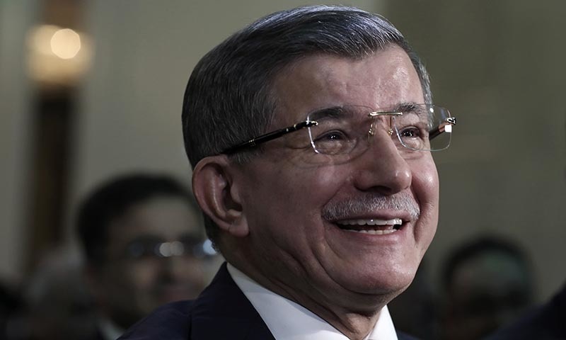 Former Turkish Prime Minister Ahmet Davutoglu smiles before addressing his supporters after he launched "The Future Party," a splinter party to rival President Recep Tayyip Erdogan, in Ankara, Turkey, on Friday. &mdash; AP
