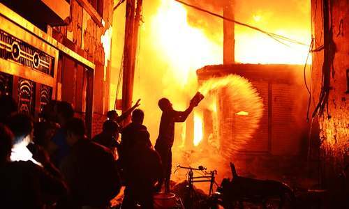 Firefighters and area residents help to douse a fire in Dhaka, Bangladesh. — AP/File Firefighters and area residents help to douse a fire in Dhaka, Bangladesh. — AP/File
