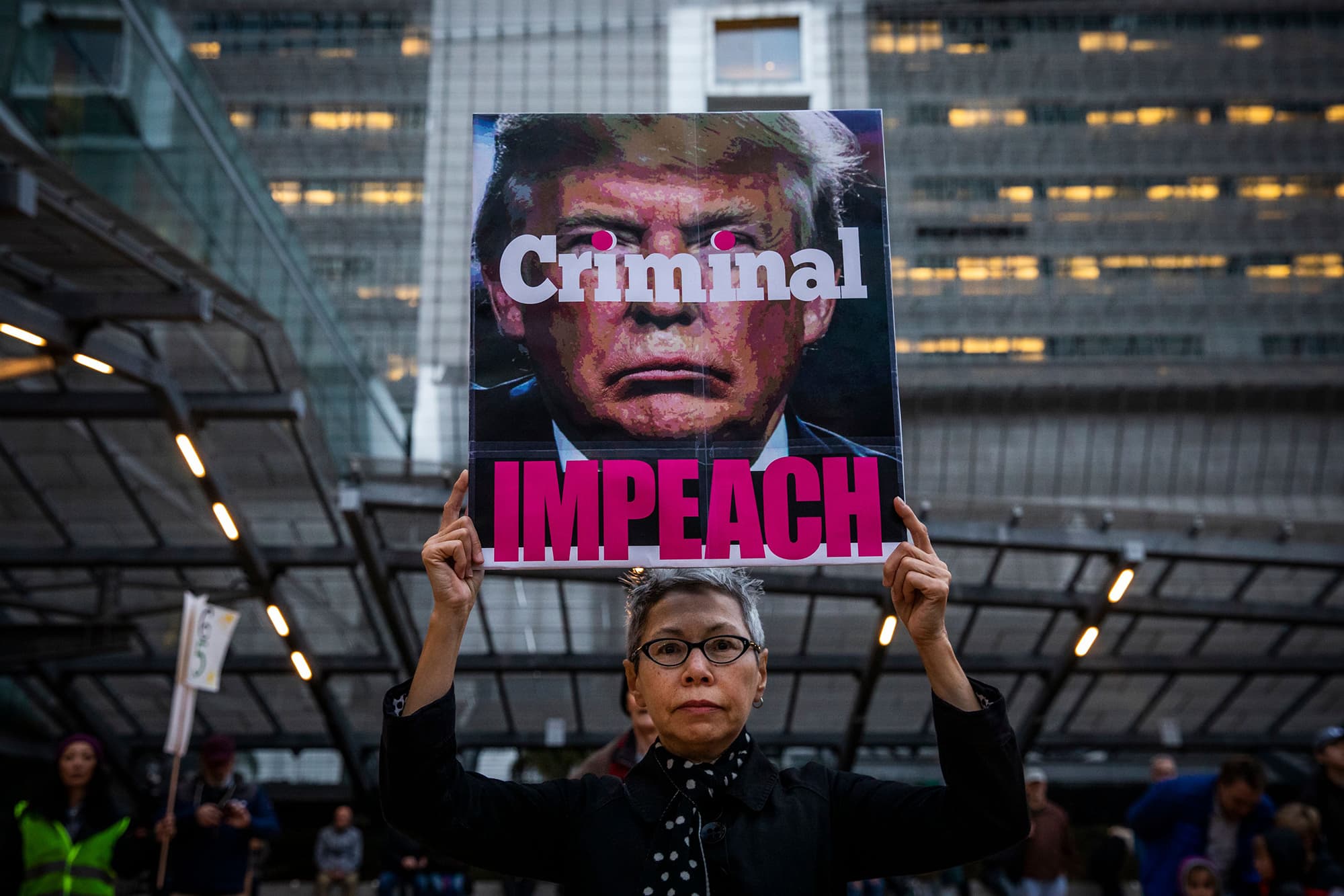 Connie Jeung-Mills of San Francisco holds a sign during a demonstration in part of a national impeachment rally, at the Federal Building in San Francisco, California on December 17, 2019. - Protesters around the nation participated in "Nobody is Above the Law" rallies on the eve of a historic Trump impeachment vote in the United States House of Representatives. (Photo by Philip Pacheco / AFP) — AFP or licensors