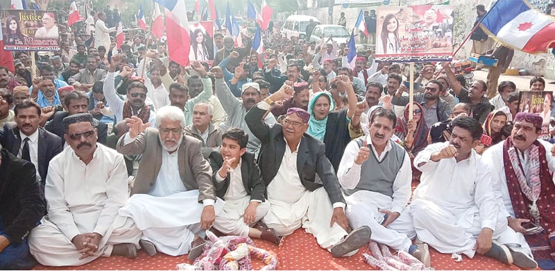 STP chairman Dr Qadir Magsi raises fist during a sit-in for justice for Dr Nimrita outside the press club on Thursday.—Online