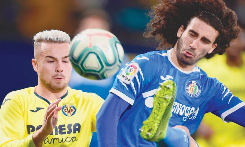 VILLARREAL: Villarreal’s Javier Ontiveros (L) vies for the ball with Getafe’s Marc Cucurella during their La Liga match at the La Ceramica Stadium.—AFP VILLARREAL: Villarreal’s Javier Ontiveros (L) vies for the ball with Getafe’s Marc Cucurella during their La Liga match at the La Ceramica Stadium.—AFP