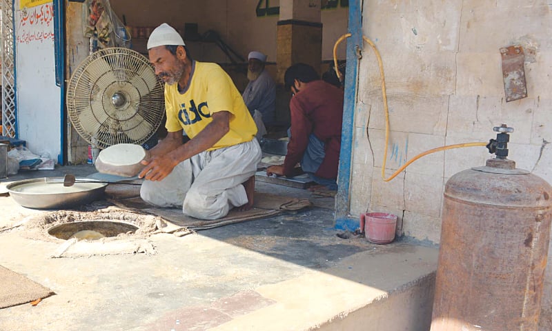 NOT only CNG stations in the city face prolonged closures, even roti-bakers (right) are compelled to use LPG in the absence of adequate gas supply.—PPI