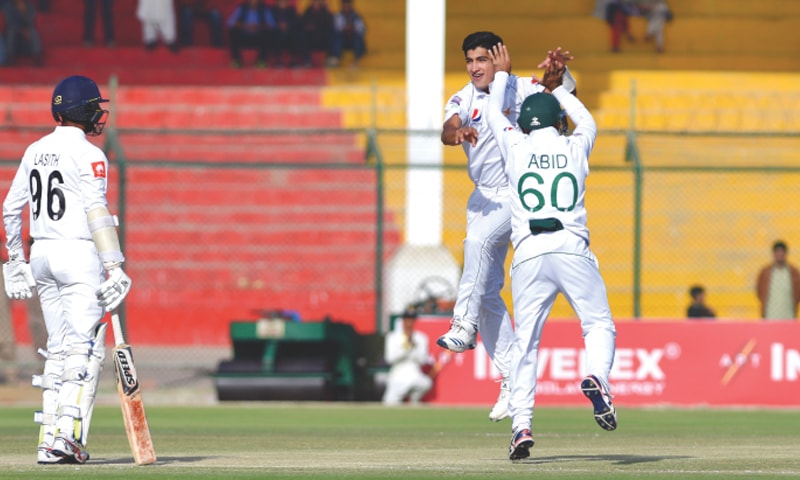 PAKISTAN paceman Nasim Shah celebrates with team-mate Abid Ali after dismissing Sri Lankan tailender Lasith Embuldeniya during the second Test at the National Stadium on Monday.
—Tahir Jamal/White Star