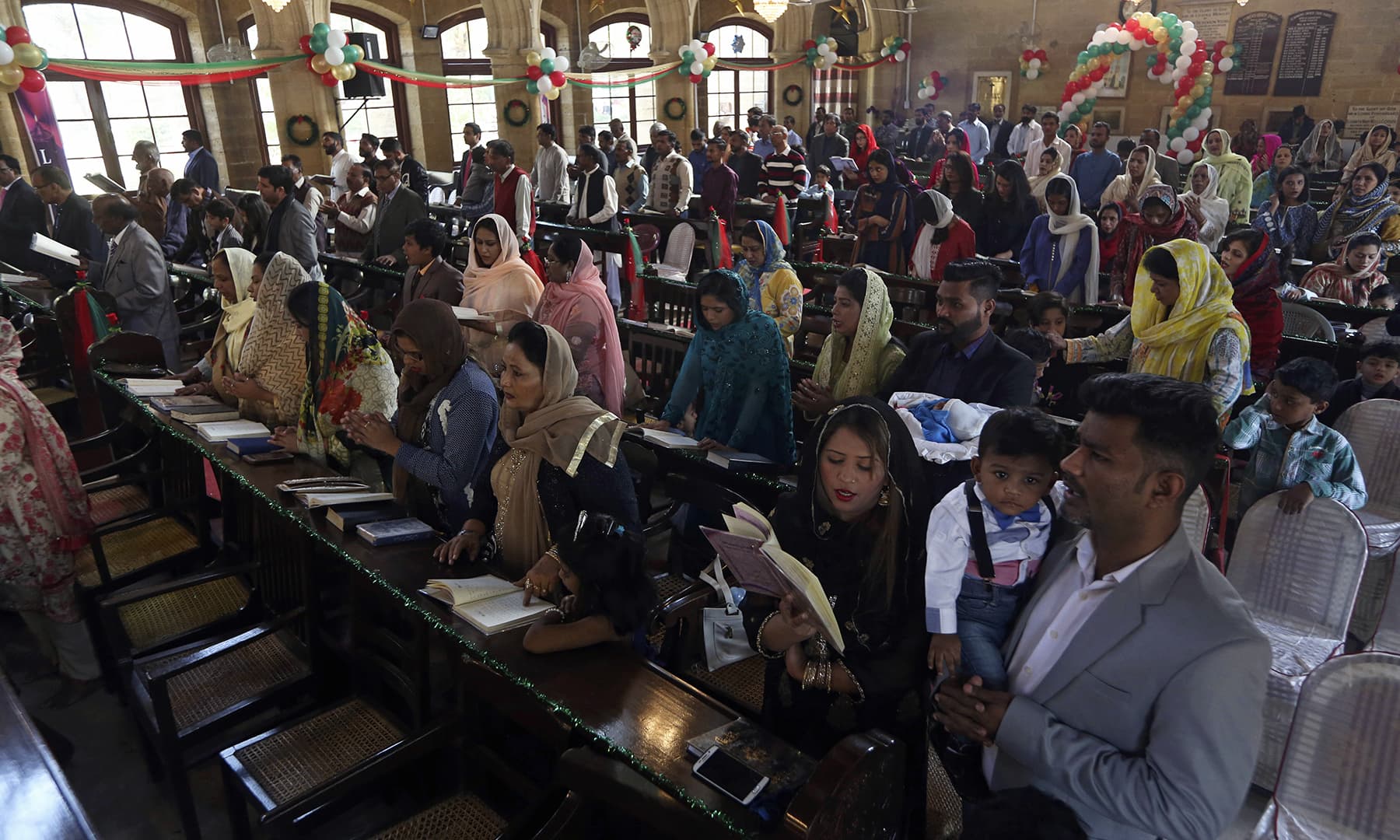 Christians attend Christmas Mass at a church in Karachi, Wednesday. &mdash; AP