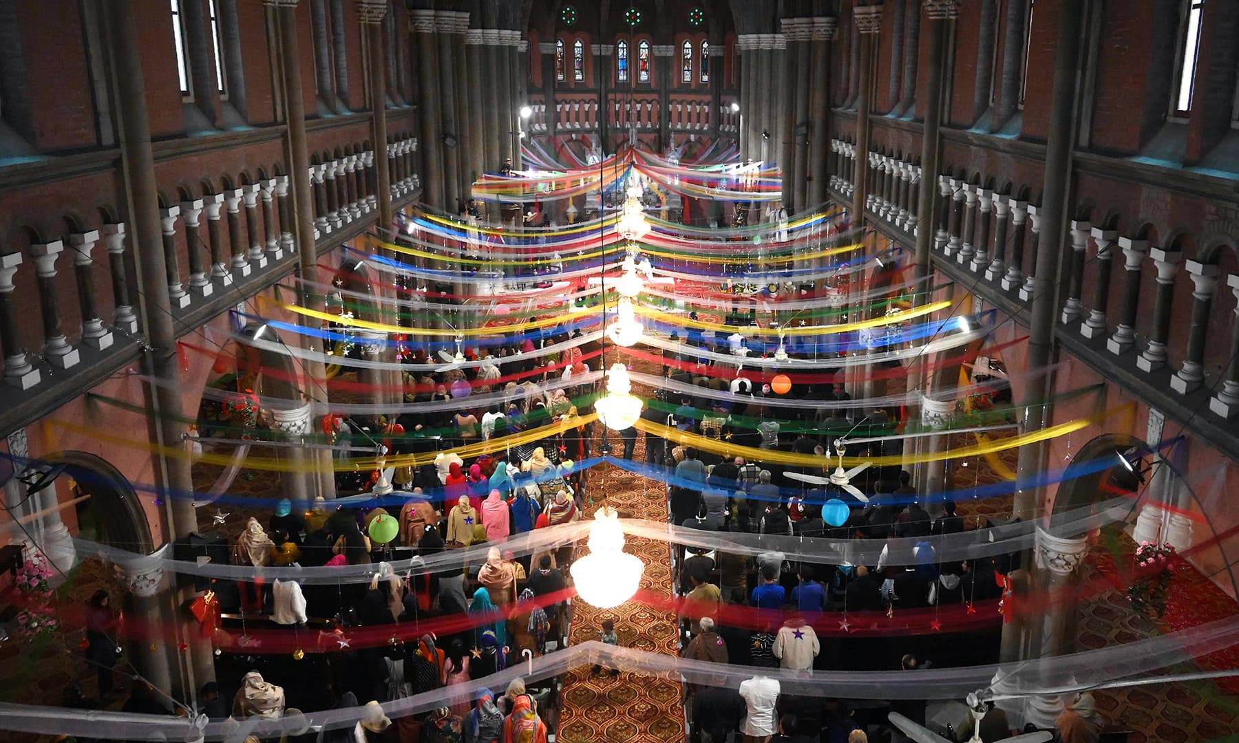 Christian devotees attend Christmas Day prayers at the Sacred Heart Church in Lahore. &mdash; AFP