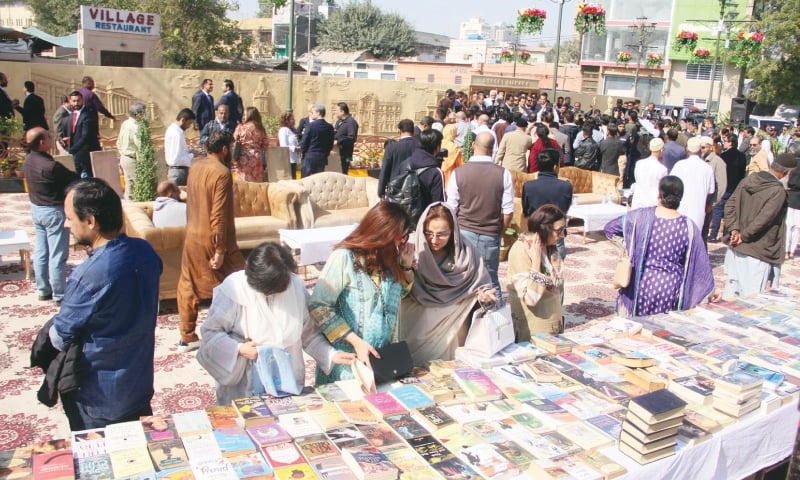 PEOPLE check out various titles at the street library on Wednesday.&mdash;Online