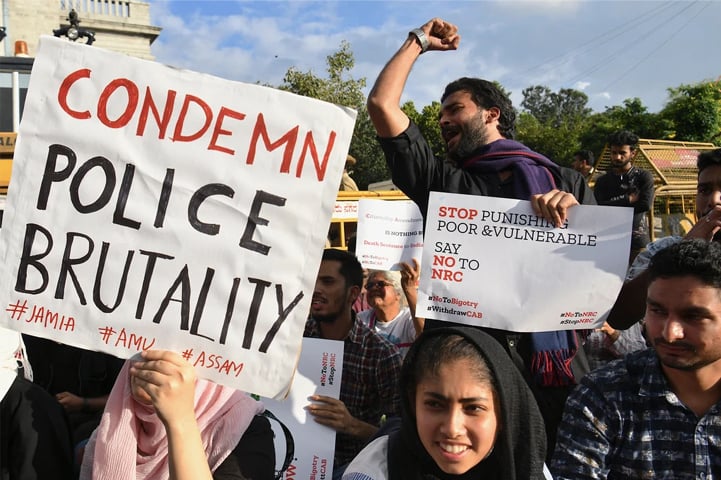 Students and activists hold placards and shout slogans in Bengaluru | AFP