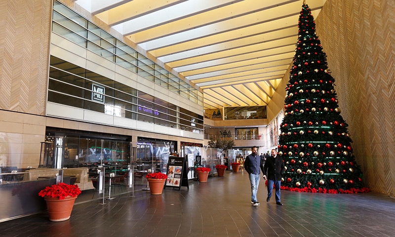 People walk past empty shops during Christmas season at Beirut Souks in downtown Beirut, Lebanon on December 17. — Reuters People walk past empty shops during Christmas season at Beirut Souks in downtown Beirut, Lebanon on December 17. — Reuters