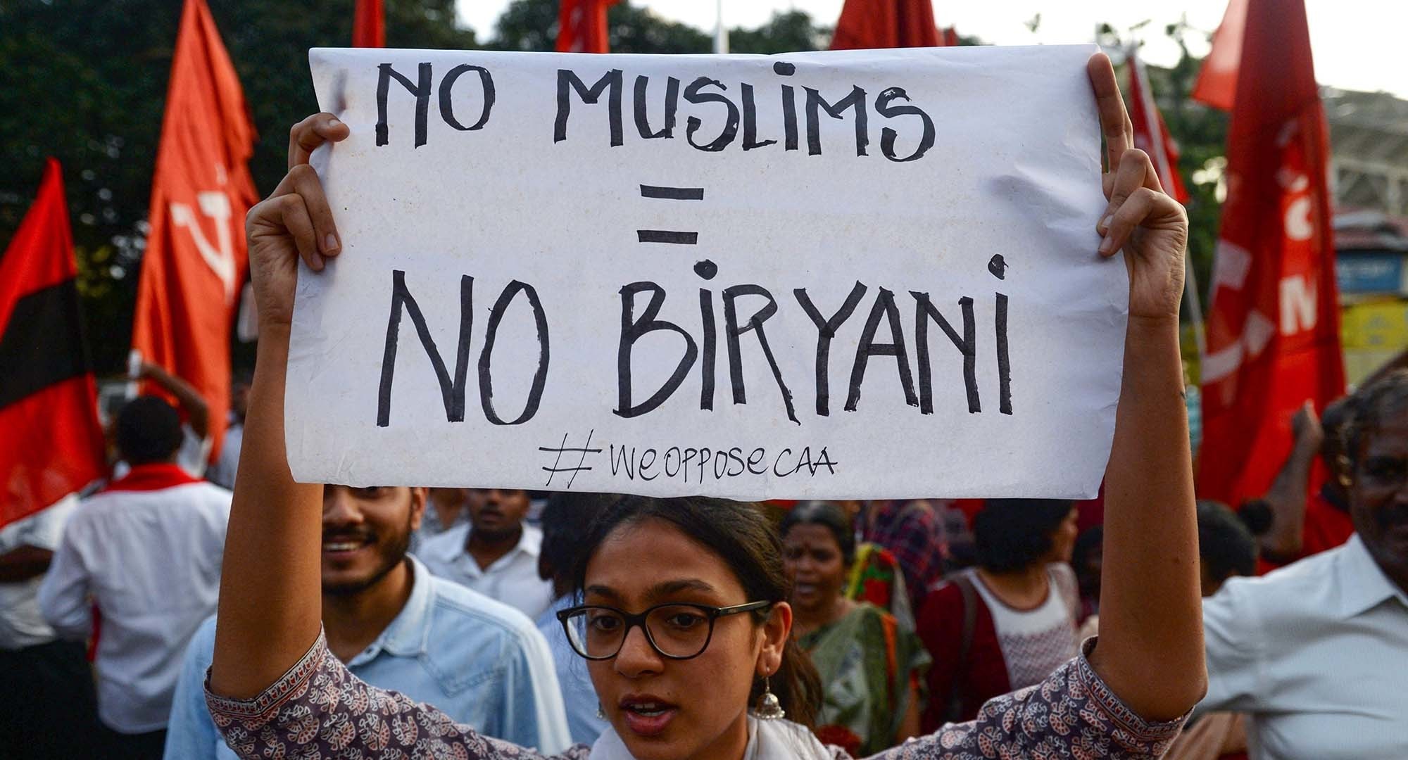 (FILES) In this file photo taken on December 16, 2019, protesters shout slogans and hold placards at a demonstration against India's new citizenship law. - From Netflix to Hitler, protesters are tapping pop culture and history as they vent their anger against Prime Minister Narendra Modi's new citizenship law -- and with deft use of India's beloved acronyms. (Photo by Arun SANKAR / AFP) — AFP or licensors