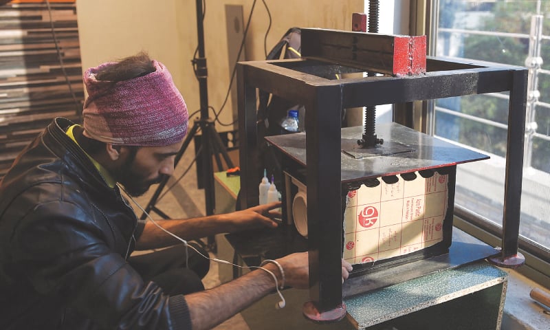 Lahore: A worker makes an air purifier device at Hasan Zaidi&rsquo;s workshop&mdash;AFP