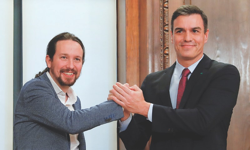 Madrid: Spain&rsquo;s acting Prime Minister Pedro Sanchez and Unidas Podemos (Together We Can) leader Pablo Iglesias shake hands as they present their coalition agreement at Parliament on Monday.&mdash;Reuters