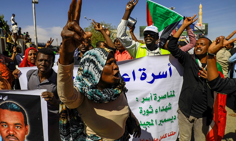 Sudanese civilians celebrate after the sentencing of 27 members of the national intelligence service to death by hanging over the killing of a teacher in detention in February during protests that led to the overthrow of former president Omar al-Bashir, outside the court in Omdurman, Sudan on December 30. &mdash; Reuters