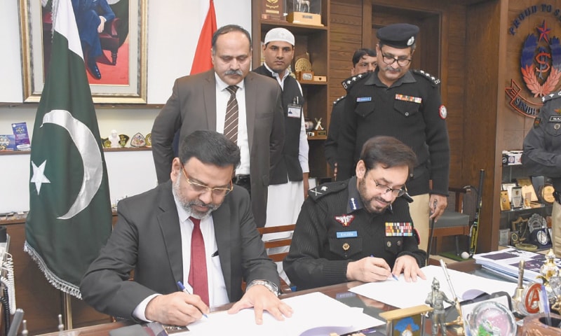 THE KU vice chancellor and the IGP sign the agreement on Friday.