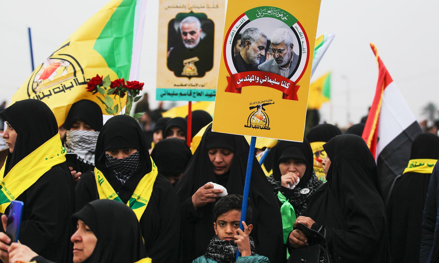 Supporters of the Hashed al-Shaabi paramilitary force and Iraq's Hezbollah brigades attend the funeral of Iranian military commander Qasem Soleimani (portrait) and Iraqi paramilitary chief Abu Mahdi al-Muhandis (portrait) in Baghdad's district of al-Jadriya, in Baghdad's high-security Green Zone, on Saturday. — AFP