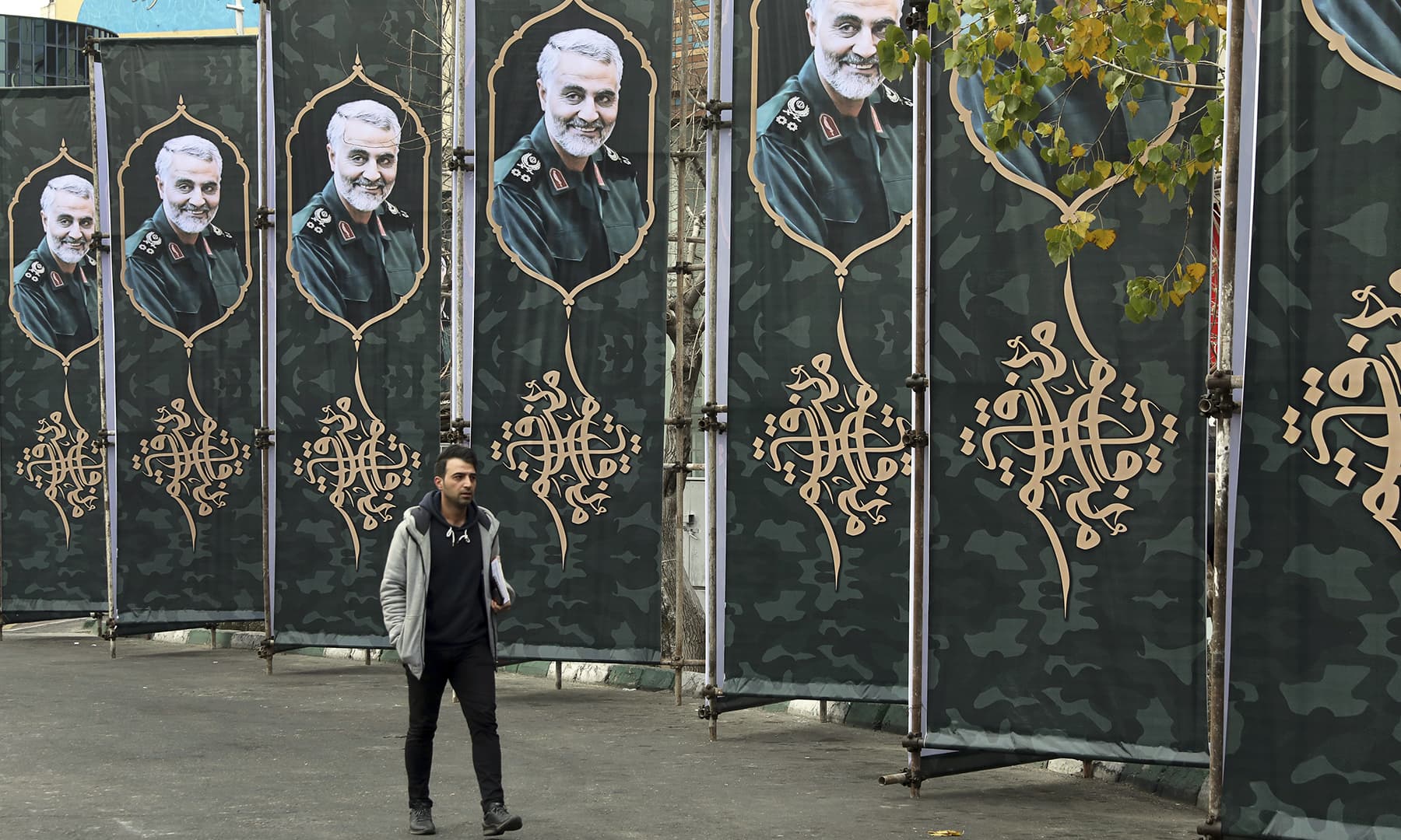 A pedestrian walks past banners showing a portrait of Iranian Revolutionary Guard Gen. Qassem Soleimani, who was killed in a US airstrike early Friday in Iraq, in Tehran, Iran, Saturday. — AP