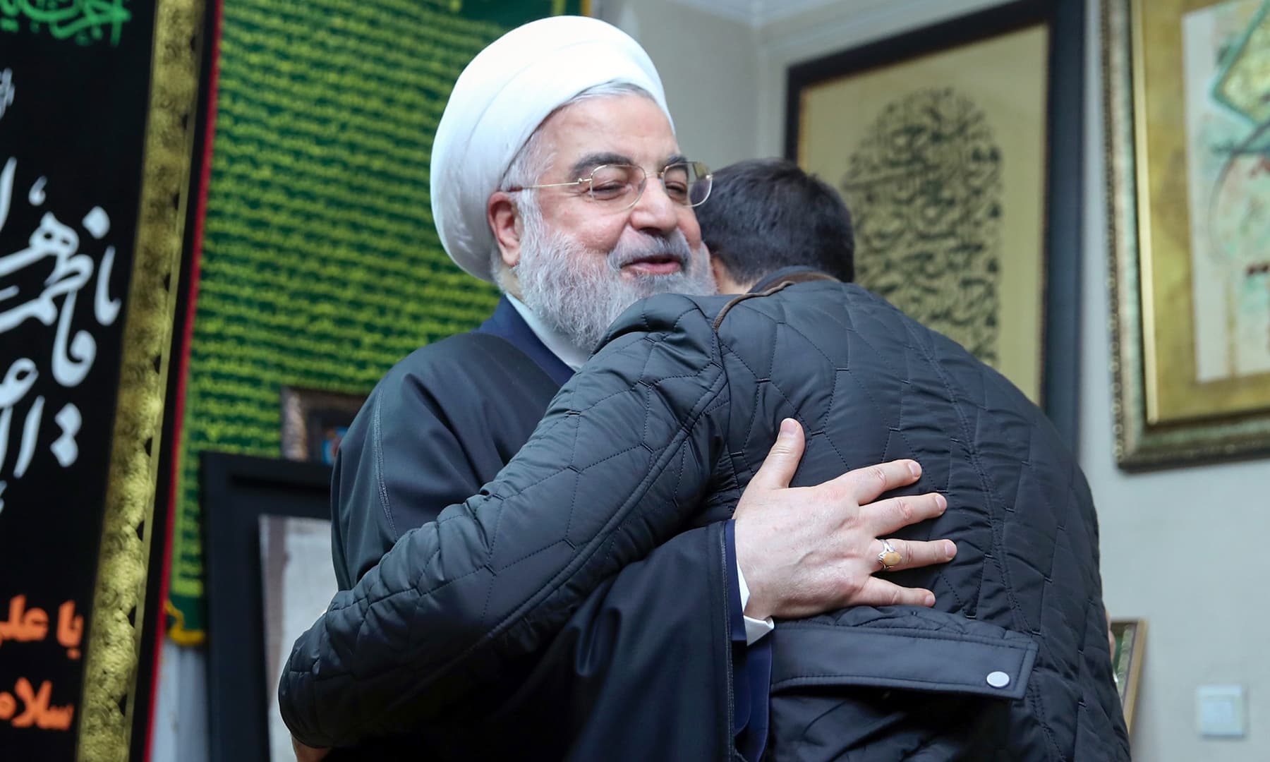 A handout picture provided by the Iranian presidency on Saturday, shows President Hassan Rouhani offering his condolences to the son of killed Iranian Revolutionary Guards commander Qasem Soleimani, in the capital Tehran. — AFP