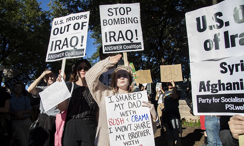 People hold signs outside the Texas state capitol in Austin, Texas on Saturday to protest the possibility of a new war in the Middle East. — Ana Ramirez/Austin American-Statesman via AP