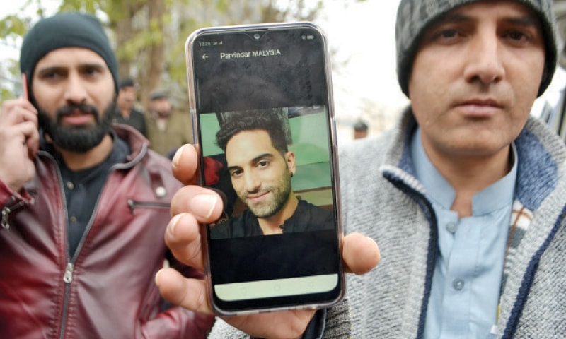 A family member shows picture of Pervinder Singh, who was found dead in Peshawar on Sunday. — White Star