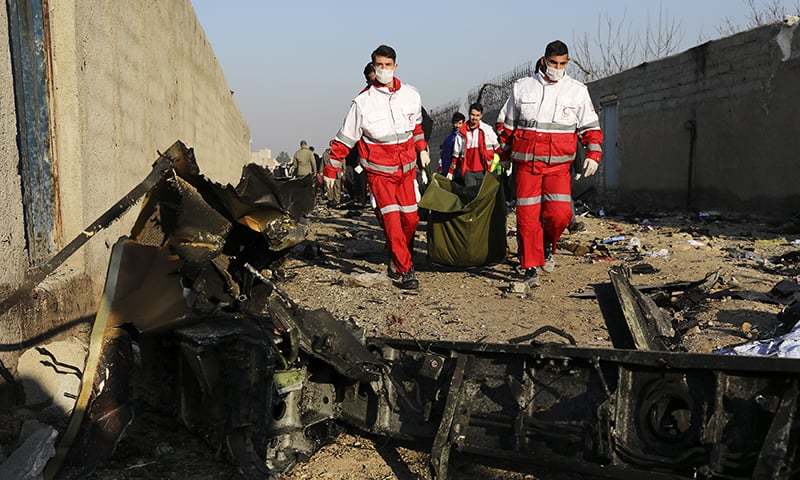 Rescue workers carry the body of a victim of an Ukrainian plane crash among debris of the plane in Shahedshahr, southwest of the capital Tehran, Iran, Wednesday, Jan. 8, 2020. — AP/File