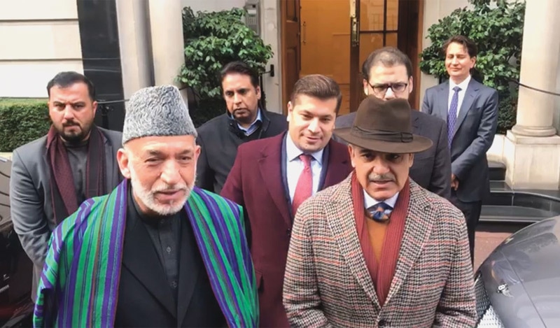 Former Afghan president Hamid Karzai with Shahbaz Sharif on Saturday.—Dawn