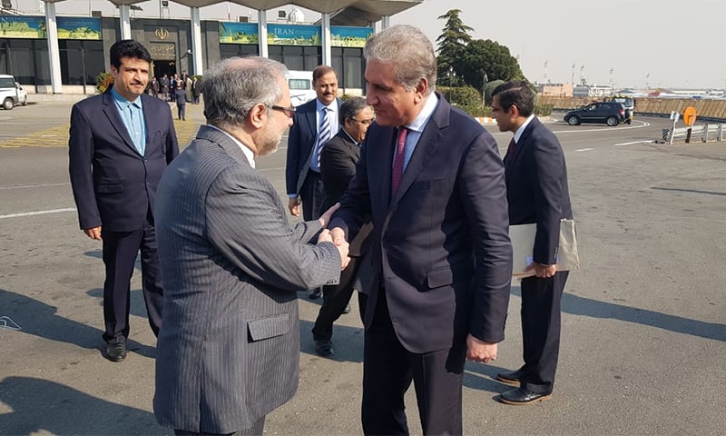 Foreign Minister Shah Mehmood Qureshi is seen off by an Iranian official upon his departure from Tehran. — Photo: FO