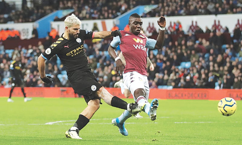 BIRMINGHAM: Manchester City&rsquo;s Sergio Aguero (L) shoots to score during the Premier League match against Aston Villa at Villa Park.&mdash;Reuters