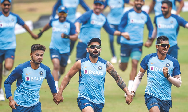 MUMBAI: Indian cricketers run holding hands as they attend a training session at the Wankhede Stadium on Monday.—AFP