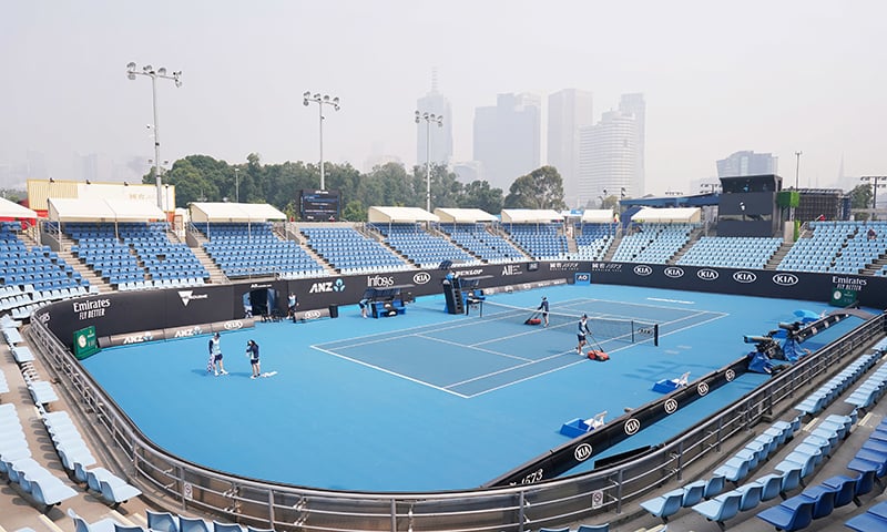 A general view is seen with the city skyline shrouded by smoke haze from bushfires during an Australian Open practice session at Melbourne Park on Jan 14. — AAP via Reuters