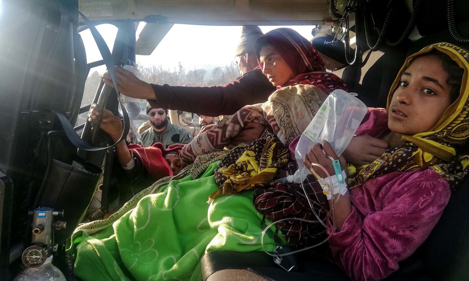 Injured avalanche victims arrive in an army helicopter following heavy snowfall in Neelum Valley. — AFP