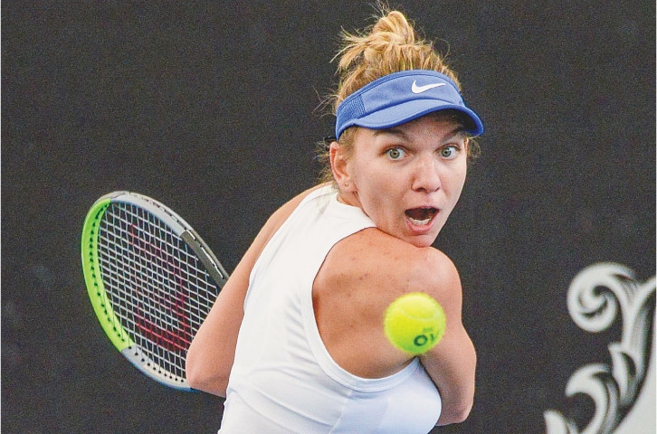 SIMONA Halep of Romania hits a return to Belarus’ Aryna Sabalenka during their Adelaide International quarter-final on Thursday.—AFP