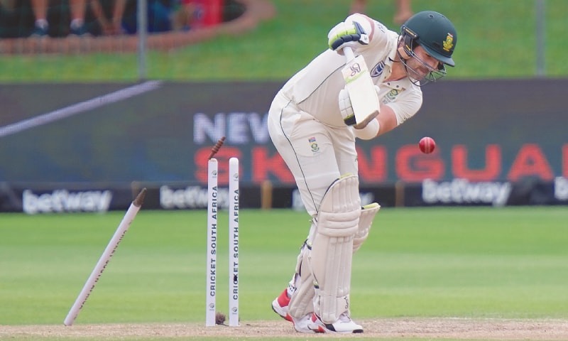 PORT ELIZABETH: South African opener Dean Elgar is cleaned up by England pacer Mark Wood during the third Test on Sunday.—AP