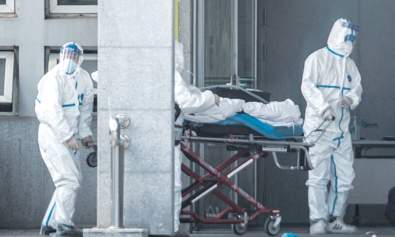 Wuhan (Hubei province, China): A patient is being carried into a hospital where those infected by a mysterious SARS-like virus are being treated.—AFP