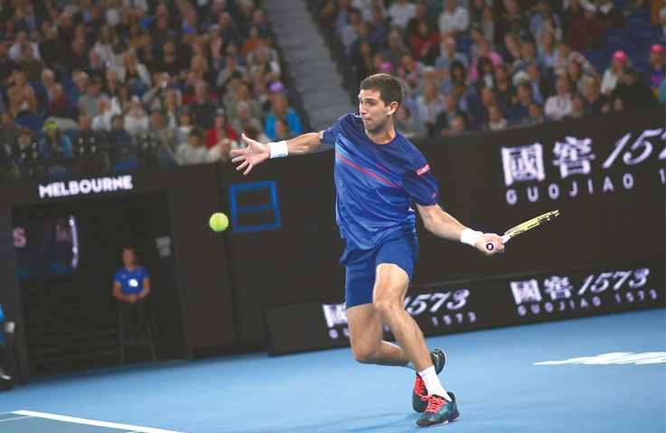 MELBOURNE: Argentina’s Federico Delbonis hits a return to Rafael Nadal of Spain during their match at the Australian Open on Thursday.—AFP