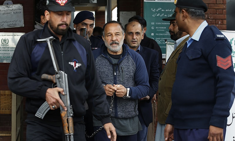 Police officers escort Piran Ditta Khan, centre, who was arrested in the killing of a British woman police officer, following his court appearance in Islamabad on Wednesday. — AP