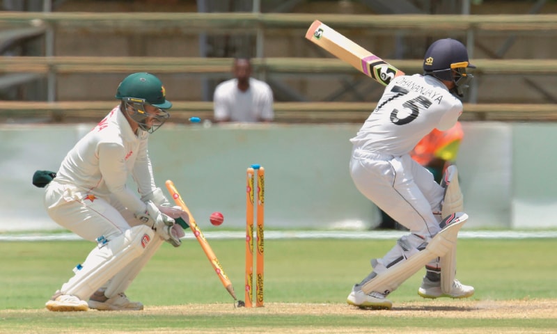 SRI LANKAN batsman Dhananjaya de Silva is bowled by Zimbabwe spinner Sikandar Raza as wicket-keeper Regis Chakabva looks on during the second Test at the Harare Sports Club on Wednesday.&mdash;AFP