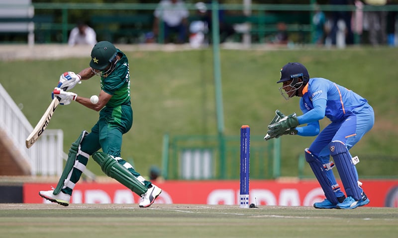 Pakistan's Fahad Munir (L) plays a shot as India's Dhruv Jurel (R) looks on during the Semi-Final of the ICC Under-19 Cricket World Cup between India and Pakistan at the Senwes Park in Potchefstroom on February 4, 2020. — AFP