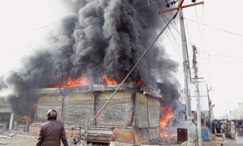TRADERS try to salvage goods from their shops amid firefighters&rsquo; attempts (below) to douse the inferno in a Malir locality on Tuesday.&mdash;PPI