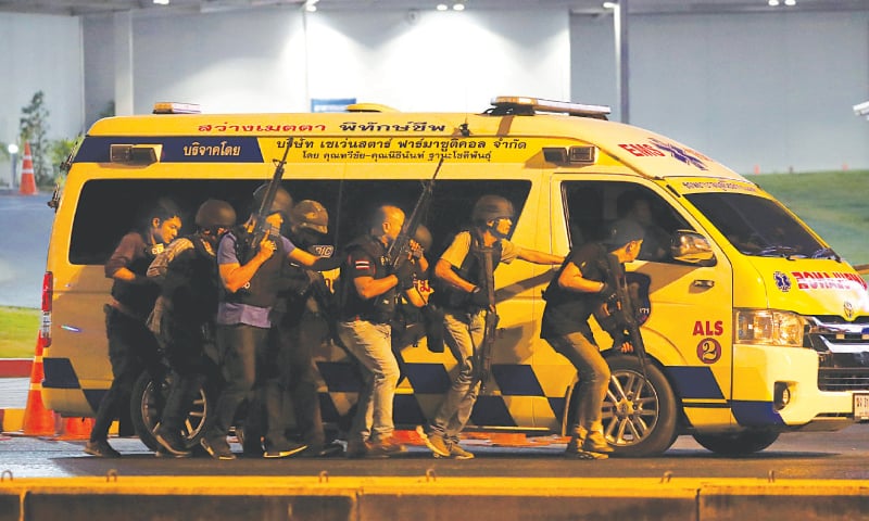 Thai security forces take cover behind an ambulance as they chase the shooter hidden in a shopping mall after a mass shooting in the city of Nakhon Ratchasima.—Reuters Thai security forces take cover behind an ambulance as they chase the shooter hidden in a shopping mall after a mass shooting in the city of Nakhon Ratchasima.—Reuters